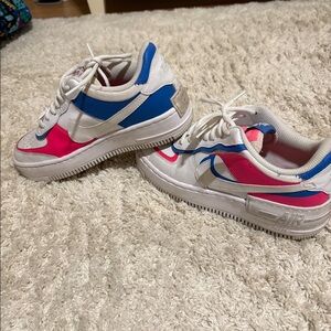 Blue and pink Nike Air Force ones